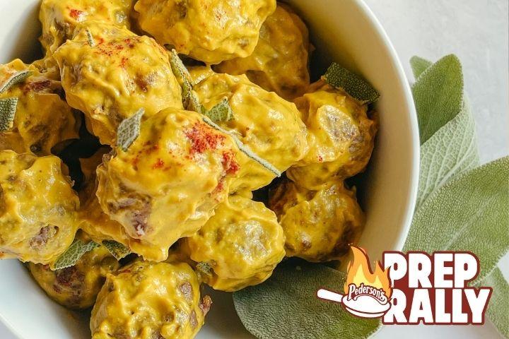 Overhead shot of Air Fryer Meatballs in a Pumpkin Sage Sauce in a white bowl on a gray countertop.