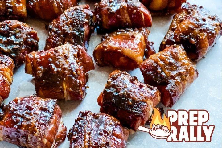 Bacon Wrapped Kielbasa Bite with a Coconut Sugar Glaze sit on a white surface