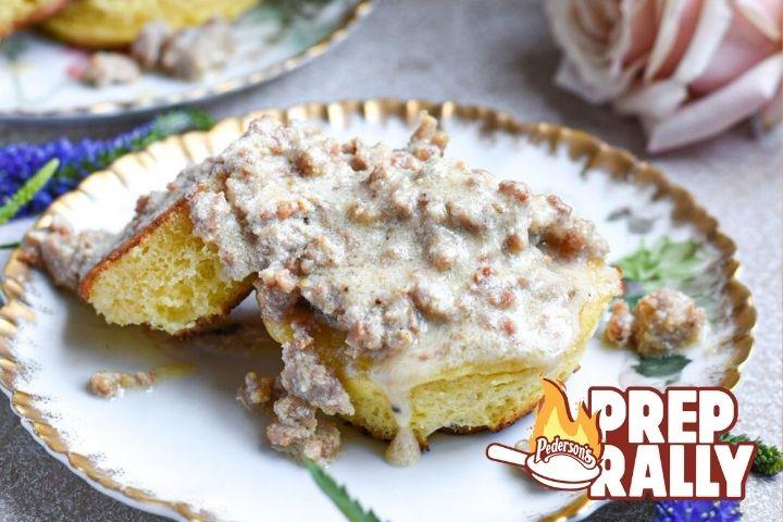 Image of cooked keto biscuits and gravy sitting on a floral plate with gold rim.