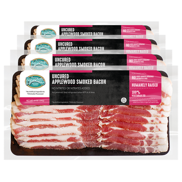image of four Apple wood smoked bacon packages stacked in front of another with bacon inside and pink/black/white label